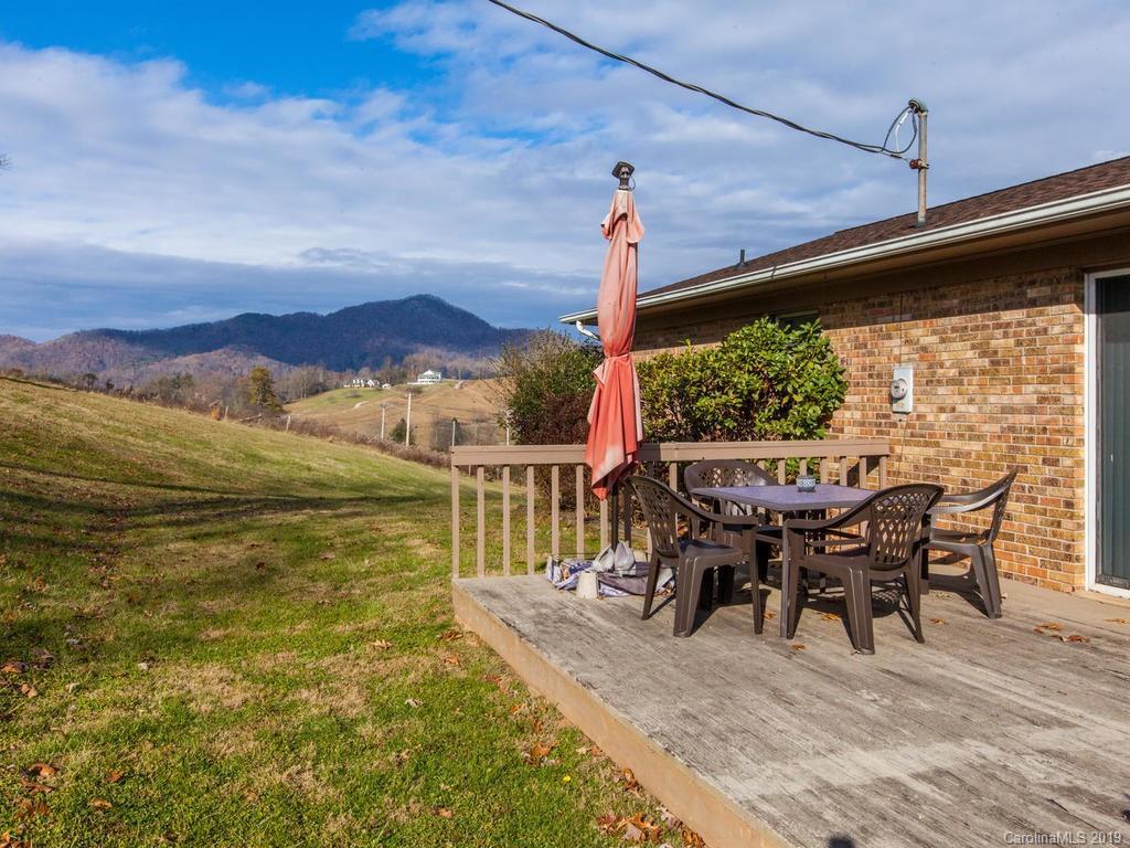 2533 Iron Duff Road Waynesville, NC 28785 - Photo 32 of 35 a view of a balcony with table and chairs