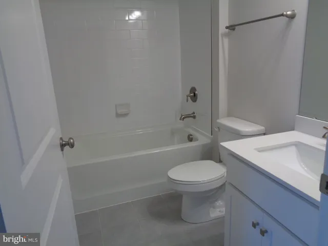 a bathroom with a sink a toilet and bathtub