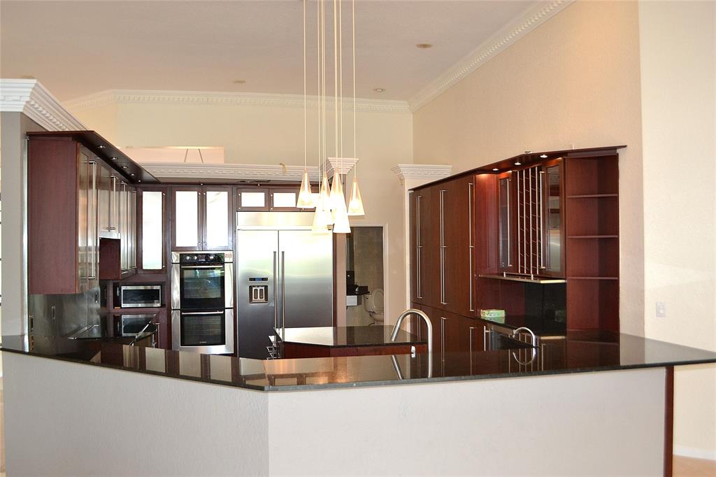 131 Dockside Circle Weston, FL 33327 - Photo 2 of 27 a kitchen with stainless steel appliances kitchen island granite countertop a refrigerator and a sink