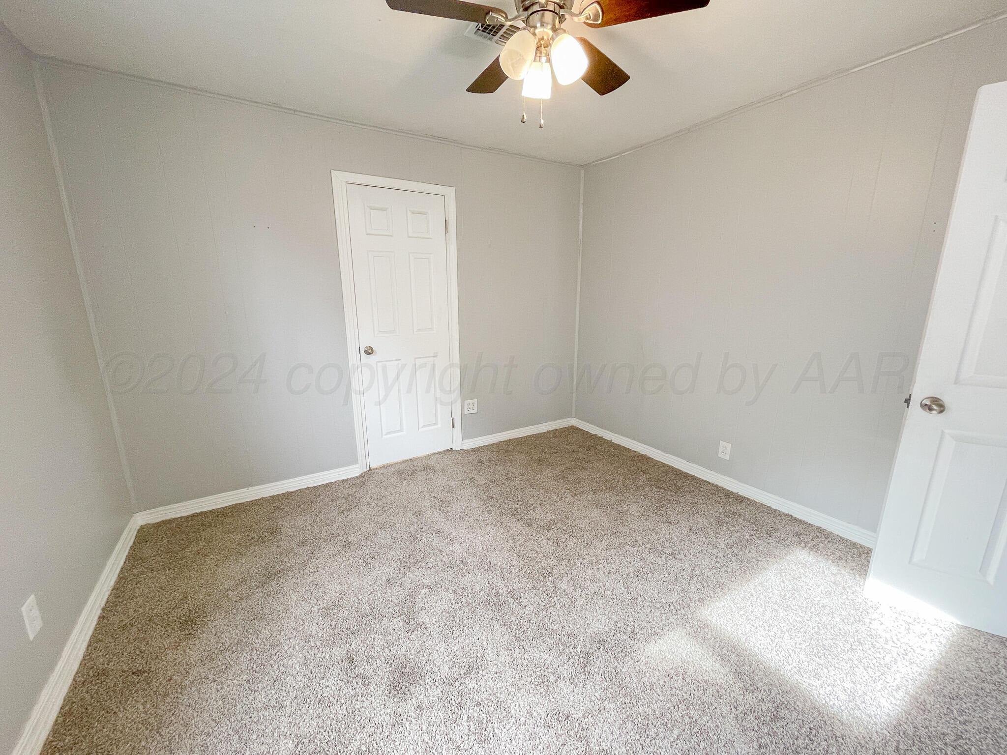 4110 South Lipscomb Street Amarillo, TX 79110 - Photo 11 of 16 an empty room with a chandelier fan