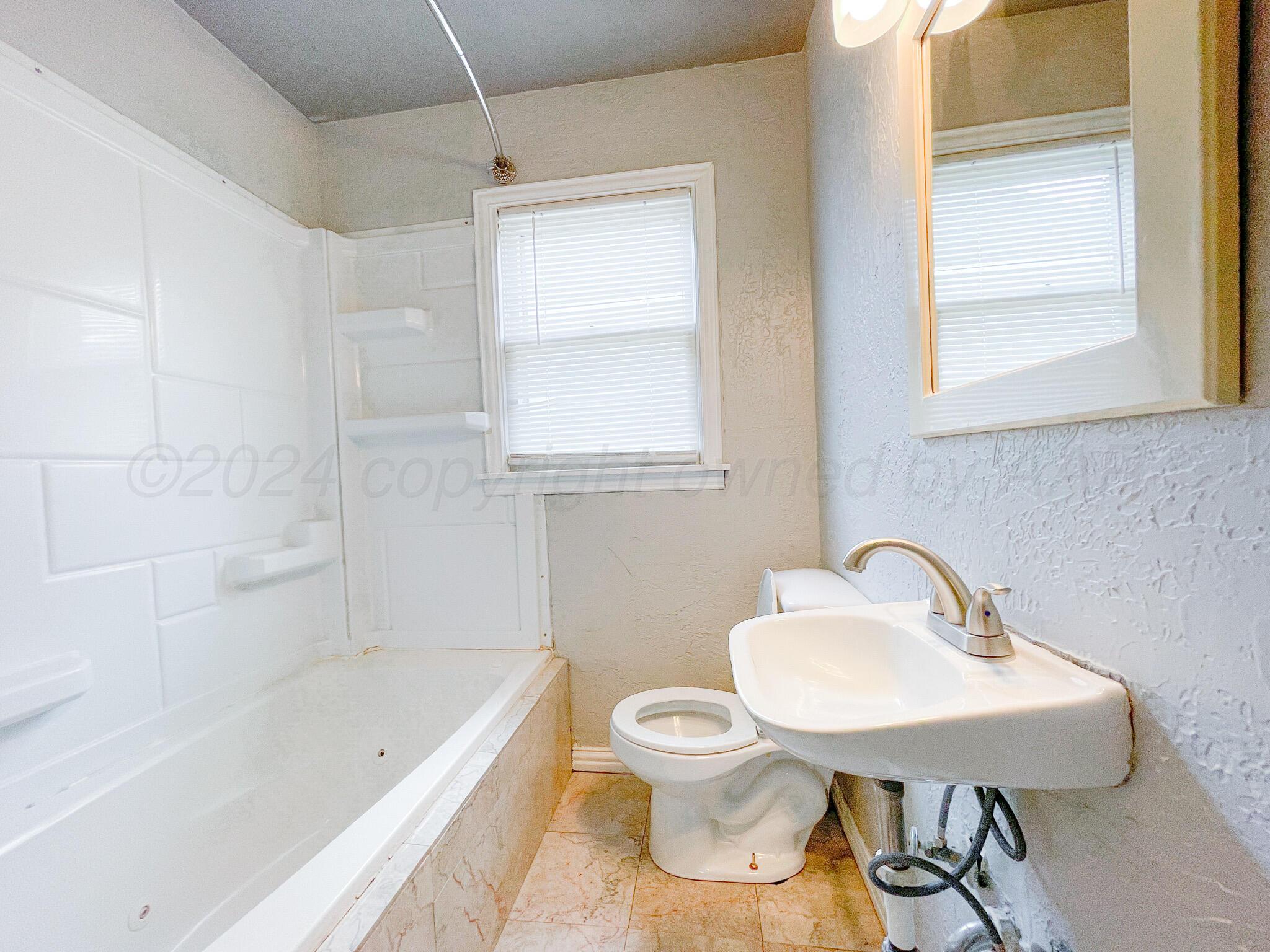 4110 South Lipscomb Street Amarillo, TX 79110 - Photo 12 of 16 a bathroom with a sink a toilet and bathtub