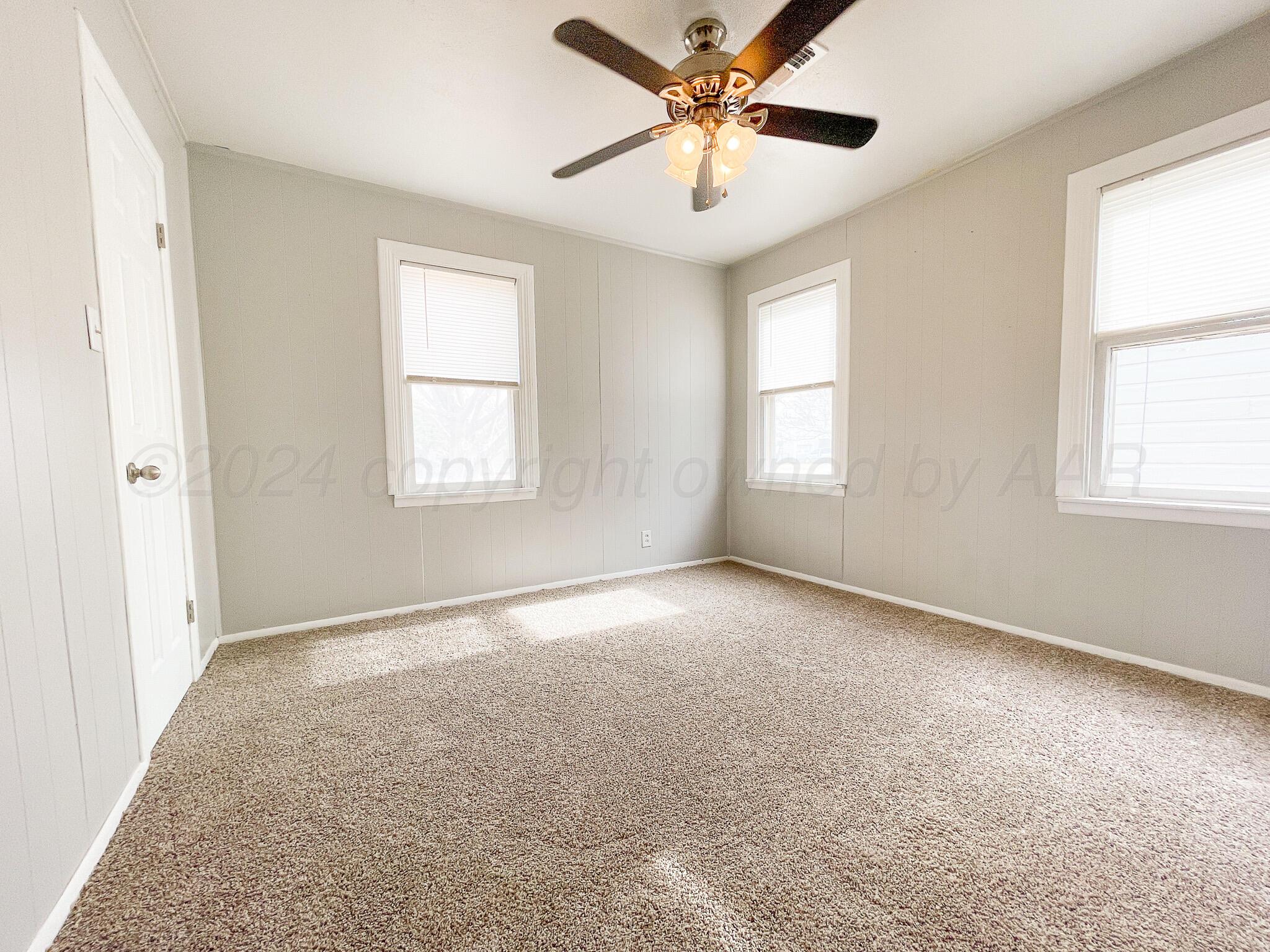 4110 South Lipscomb Street Amarillo, TX 79110 - Photo 13 of 16 an empty room with windows and chandelier fan
