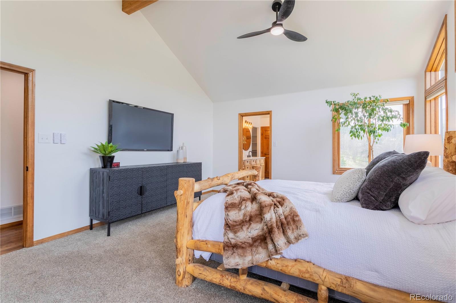 152 Bear Drive Golden, CO 80403 - Photo 14 of 40 a bedroom with a bed window and a flat screen tv