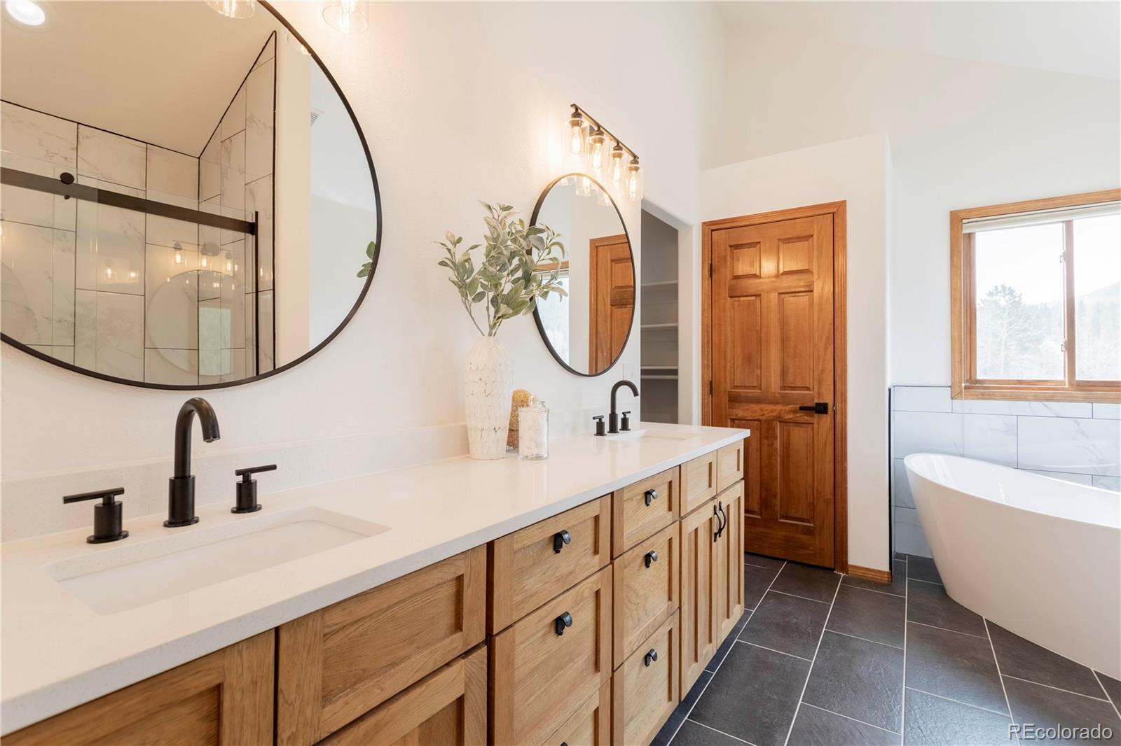 152 Bear Drive Golden, CO 80403 - Photo 15 of 40 a bathroom with a double vanity sink and a mirror