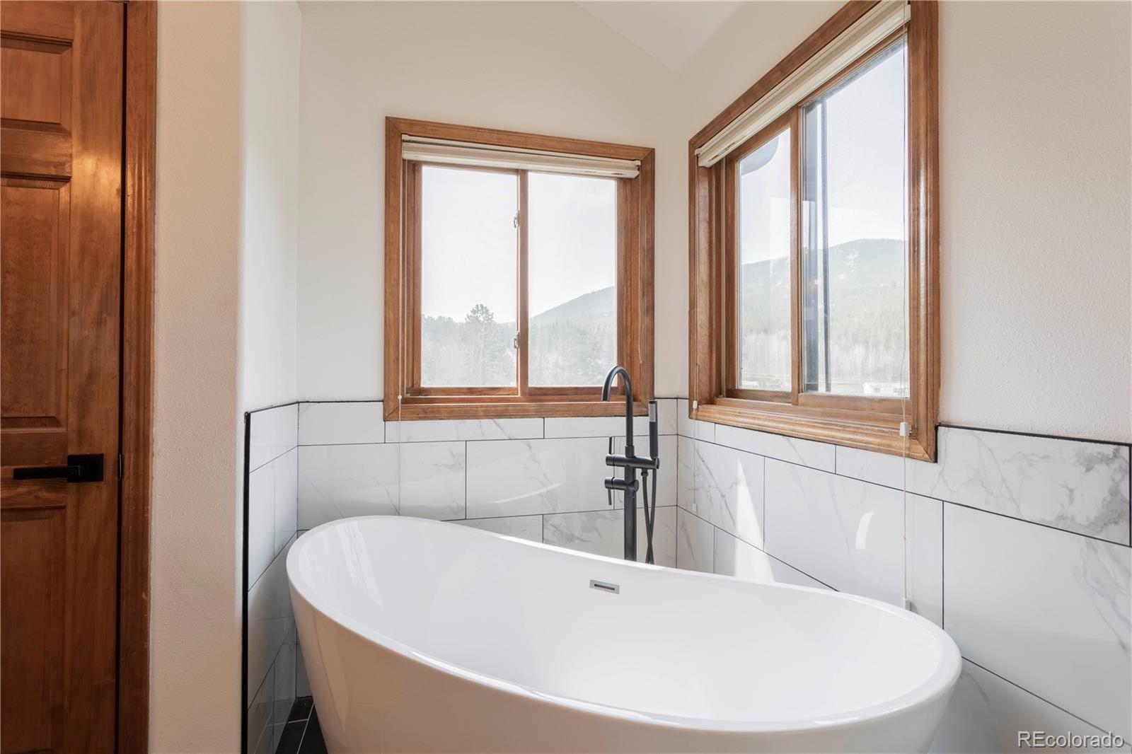 152 Bear Drive Golden, CO 80403 - Photo 16 of 40 a white bath tub sitting next to a window