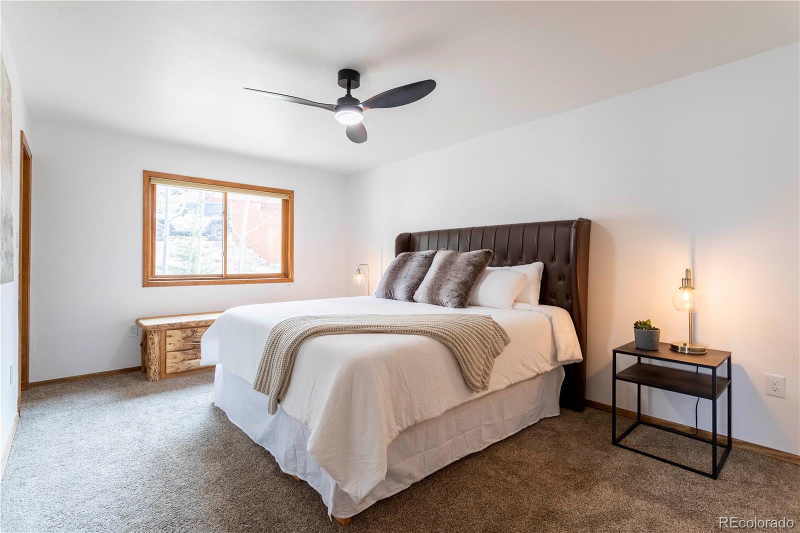152 Bear Drive Golden, CO 80403 - Photo 17 of 40 a spacious bedroom with a bed and a window