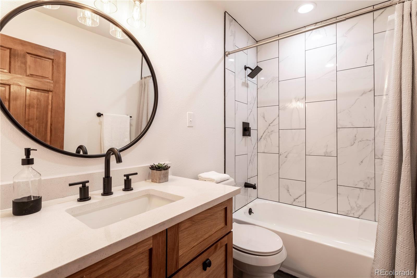 152 Bear Drive Golden, CO 80403 - Photo 18 of 40 a bathroom with a sink a toilet and a mirror