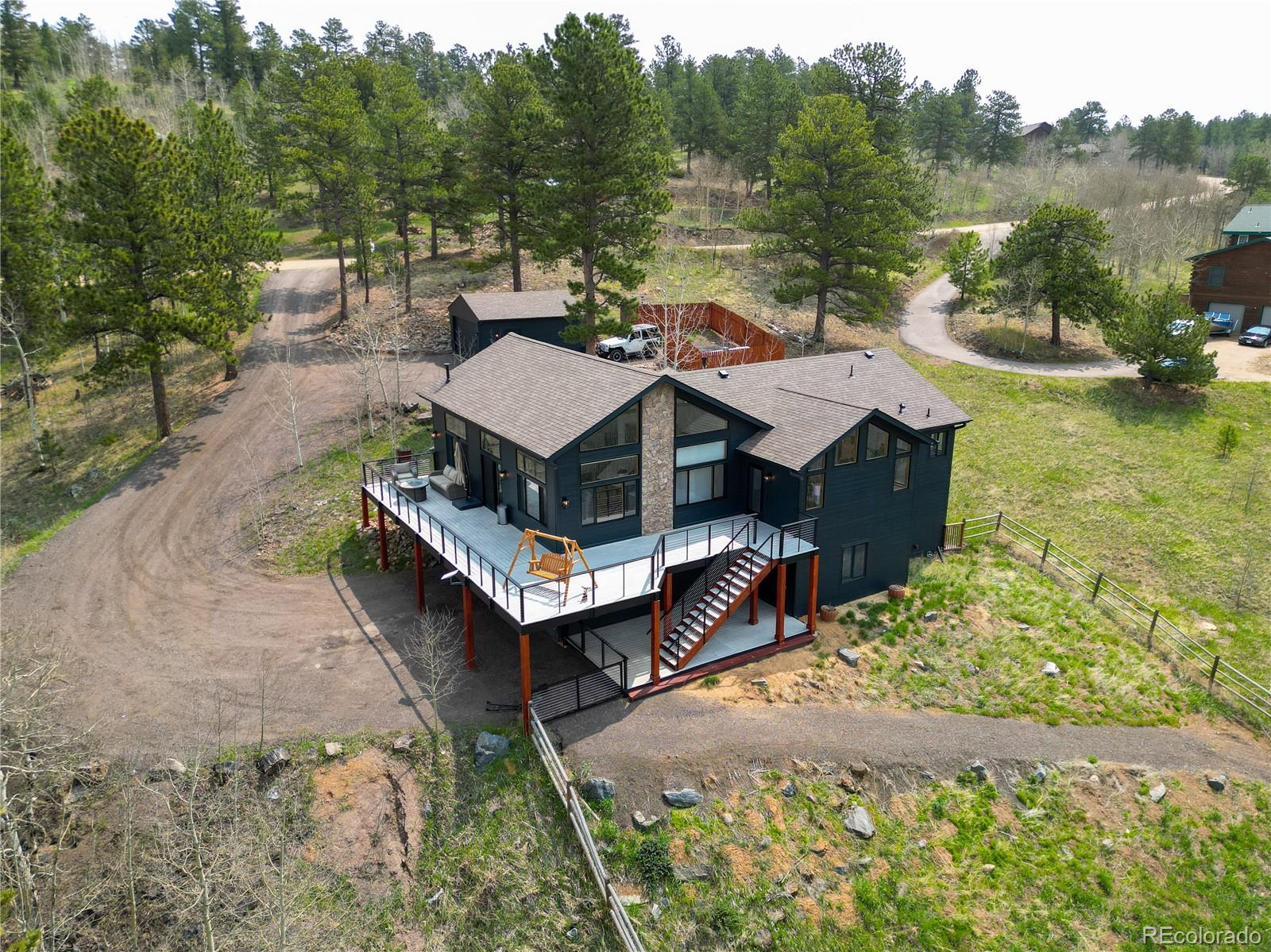 152 Bear Drive Golden, CO 80403 - Photo 2 of 40 a view of a house with pool and lake view