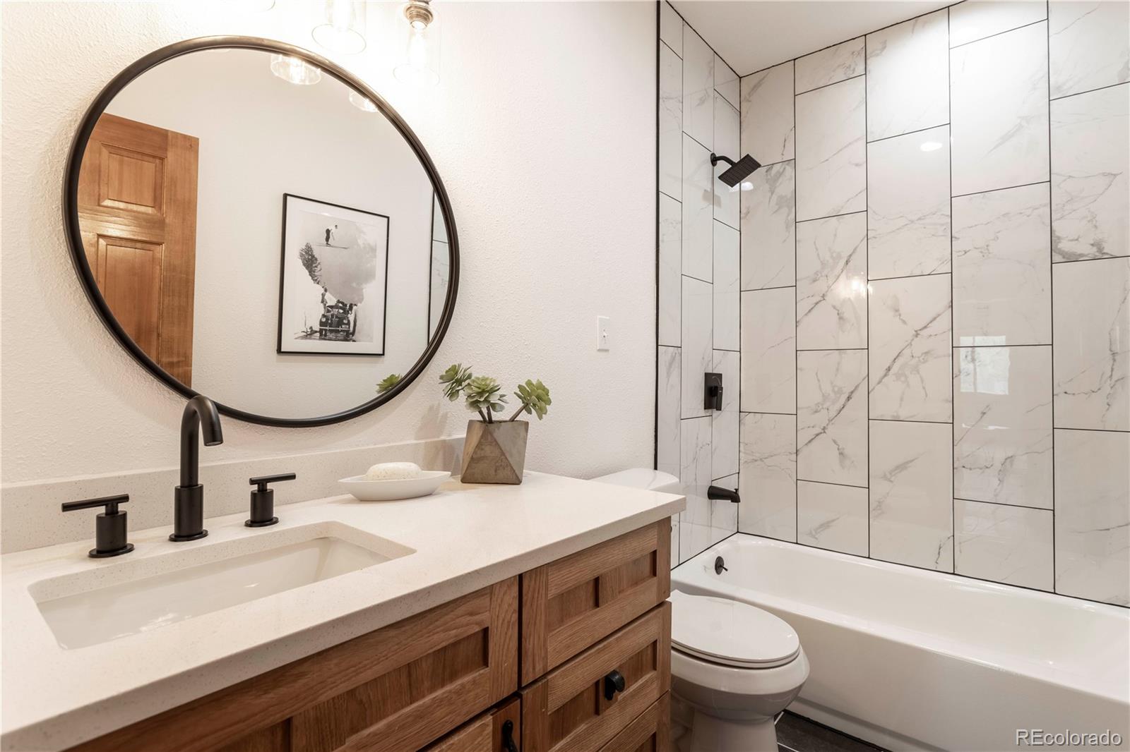 152 Bear Drive Golden, CO 80403 - Photo 24 of 40 a bathroom with a sink a toilet and a mirror