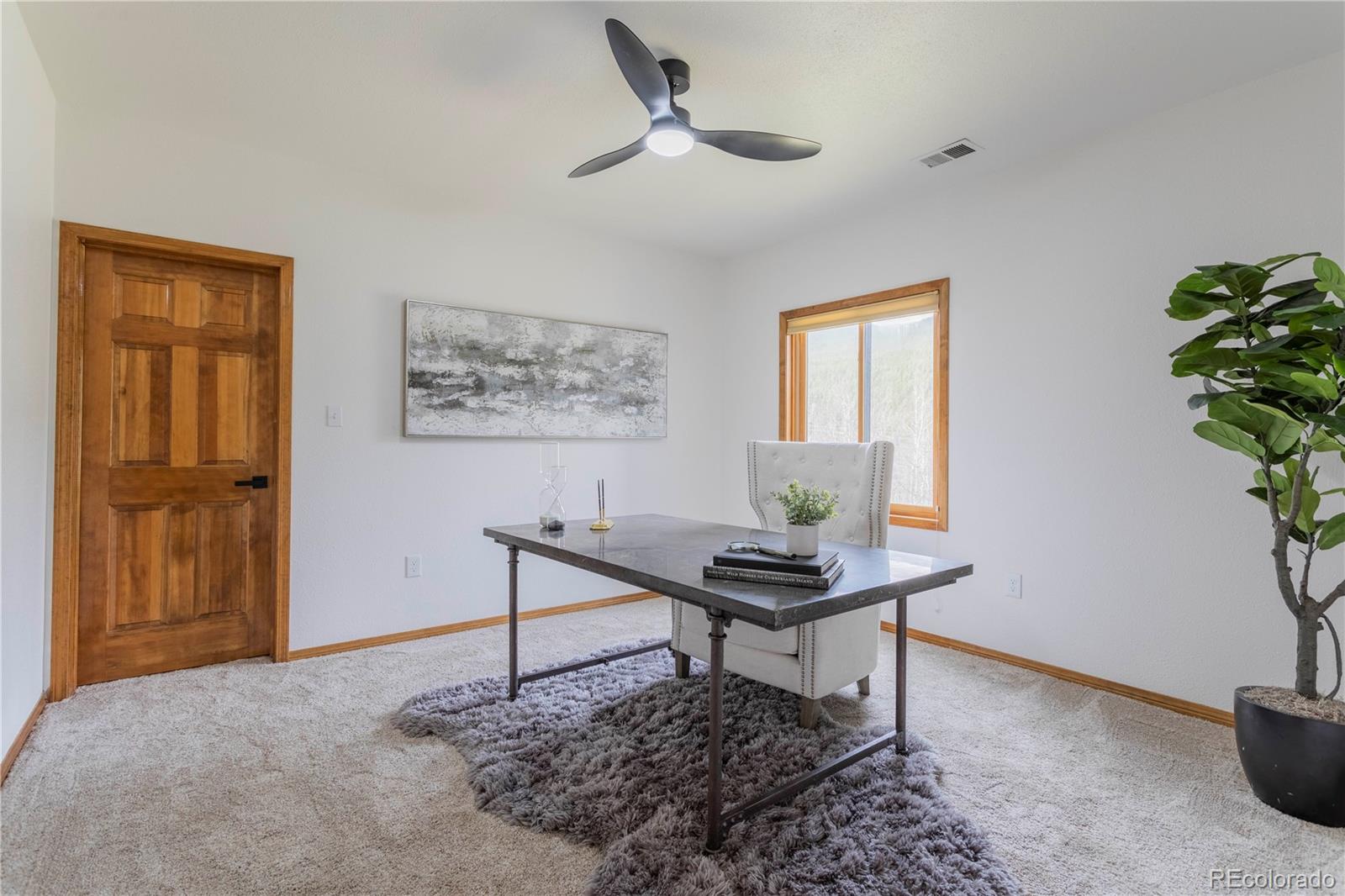 152 Bear Drive Golden, CO 80403 - Photo 25 of 40 a work room with furniture and a potted plant