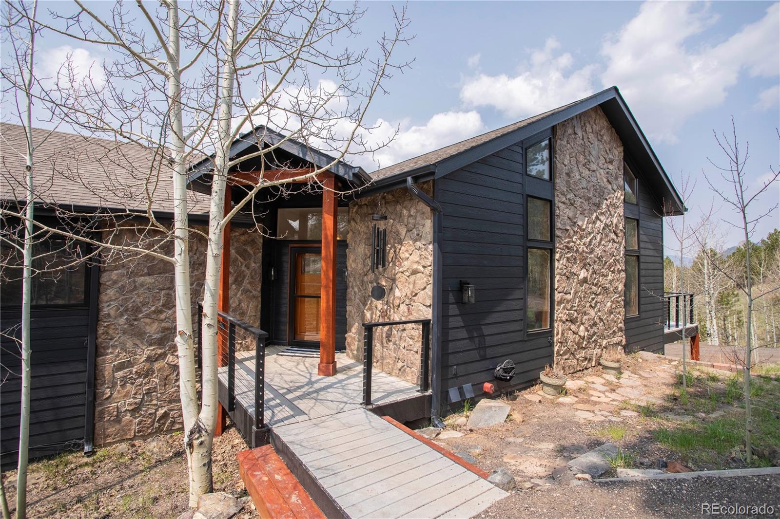 152 Bear Drive Golden, CO 80403 - Photo 4 of 40 a front view of a house with a yard