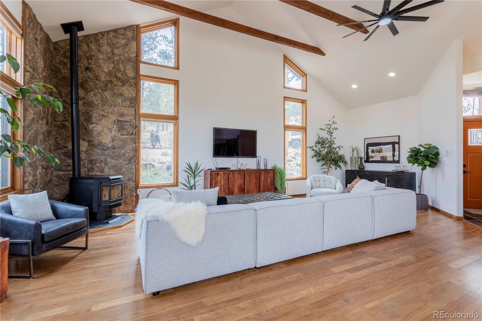 152 Bear Drive Golden, CO 80403 - Photo 8 of 40 a living room with furniture flat screen tv and a fireplace