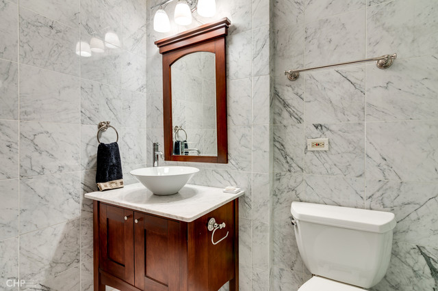 1030 North State Street, Unit 13D Chicago, IL 60610 - Photo 5 of 12 a bathroom with a toilet sink and mirror