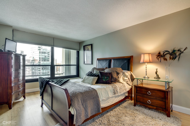 1030 North State Street, Unit 13D Chicago, IL 60610 - Photo 8 of 12 a bedroom with a bed and a large window