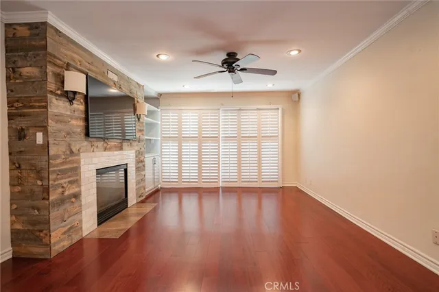 a view of an empty room with a fireplace and a window