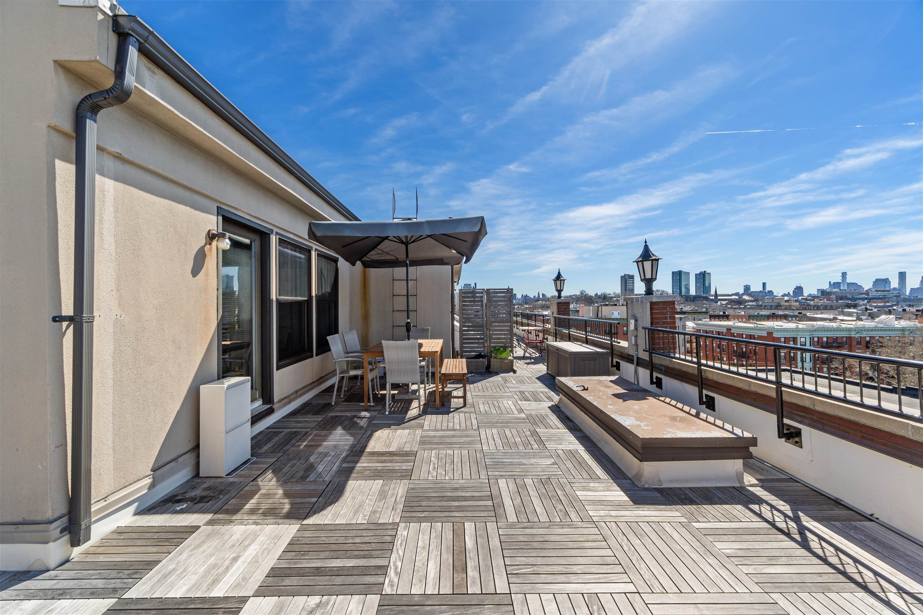 a terrace with outdoor seating and city view