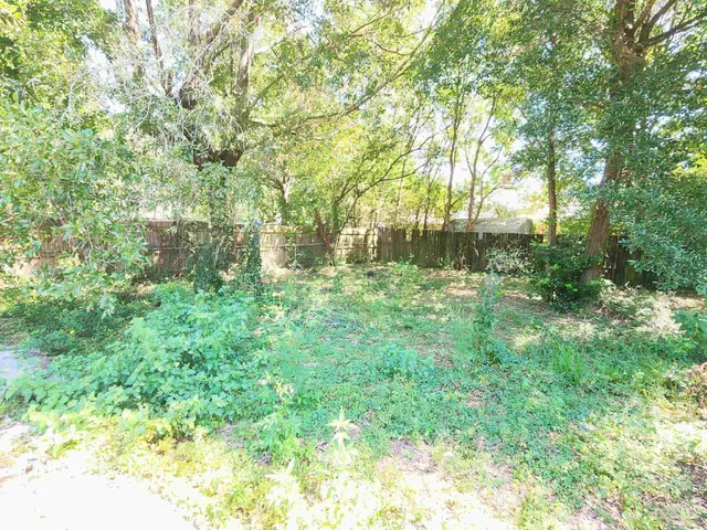 a view of outdoor space with deck and trees