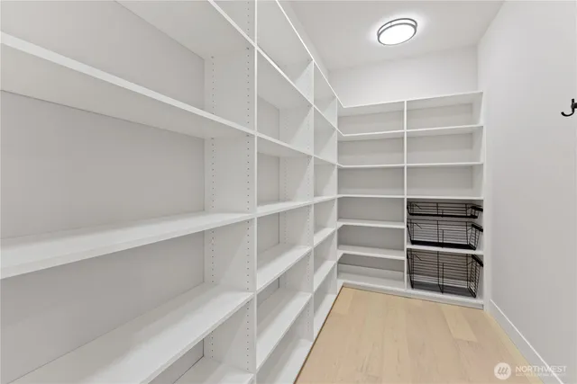 a view of walk in closet with empty racks