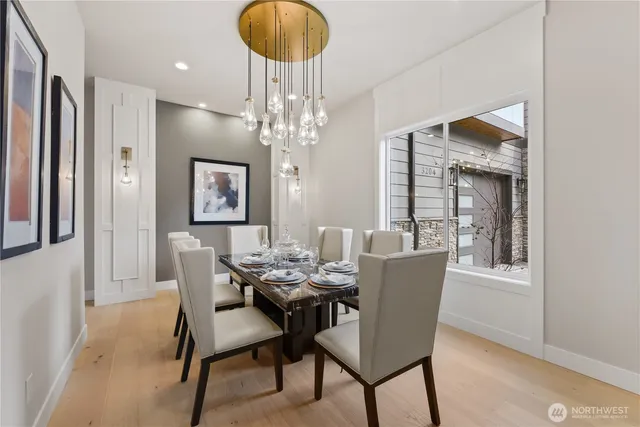 a dining room with furniture a chandelier and wooden floor