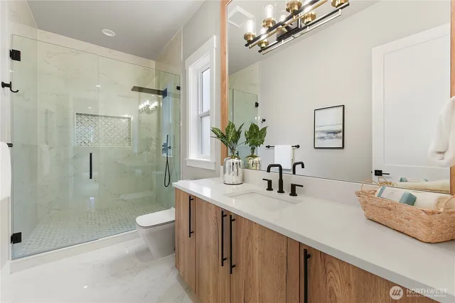 a bathroom with a double vanity sink toilet and shower