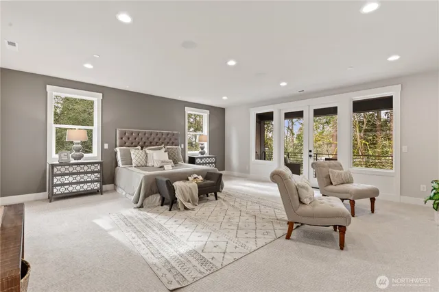 a bedroom with furniture and large windows