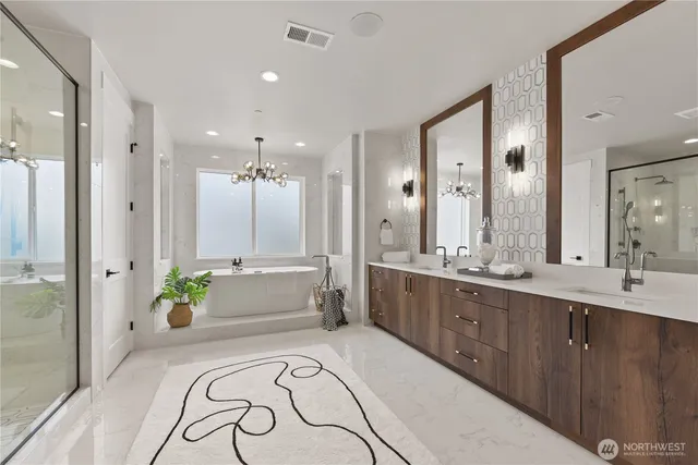 a spacious bathroom with a double vanity sink and a bathtub