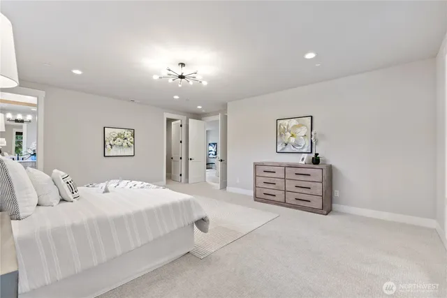 a spacious bedroom with a bed and a cabinets