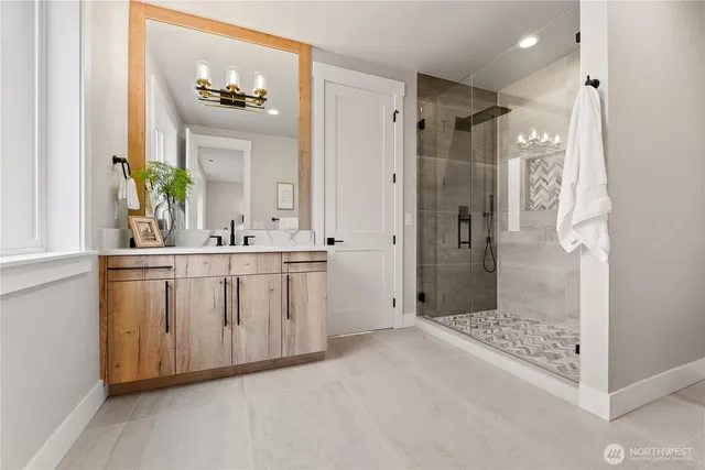 a bathroom with a granite countertop sink mirror and shower