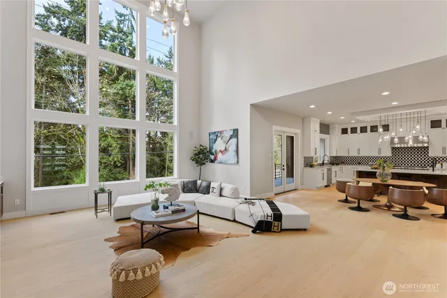 a living room with furniture and large windows