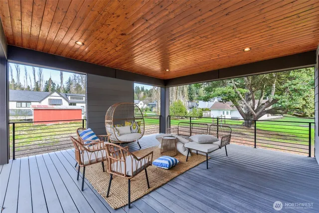 a balcony with furniture and wooden floor