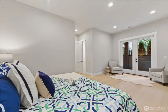 a bedroom with a bed and a large mirror