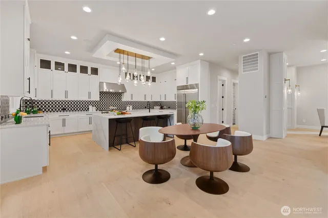 a large kitchen with a table and chairs