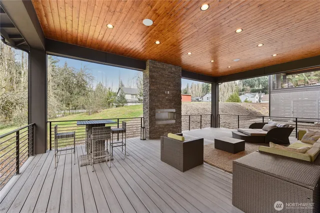 a living room with furniture a large window with kitchen view
