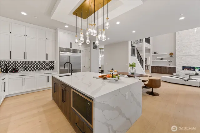 a kitchen with a sink appliances and cabinets