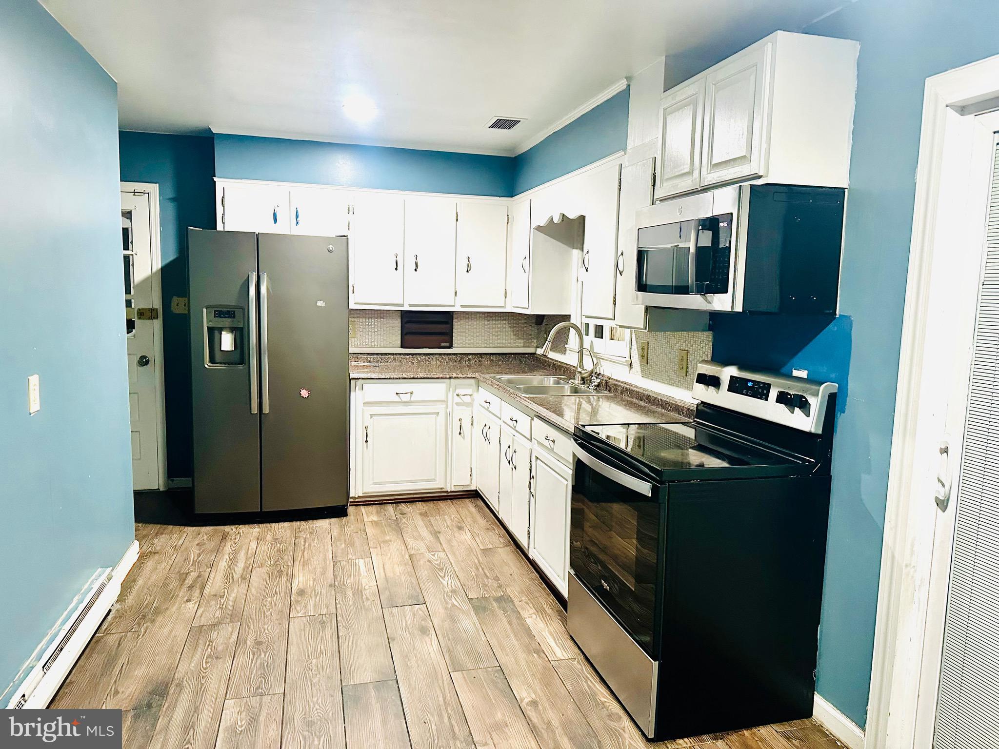 323 Russelcroft Road Winchester, VA 22601 - Photo 24 of 40 a kitchen with stainless steel appliances granite countertop a refrigerator a stove top oven a sink and dishwasher
