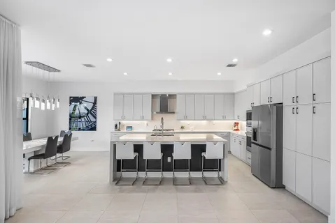 a view of a dining room with furniture a chandelier window and outside view