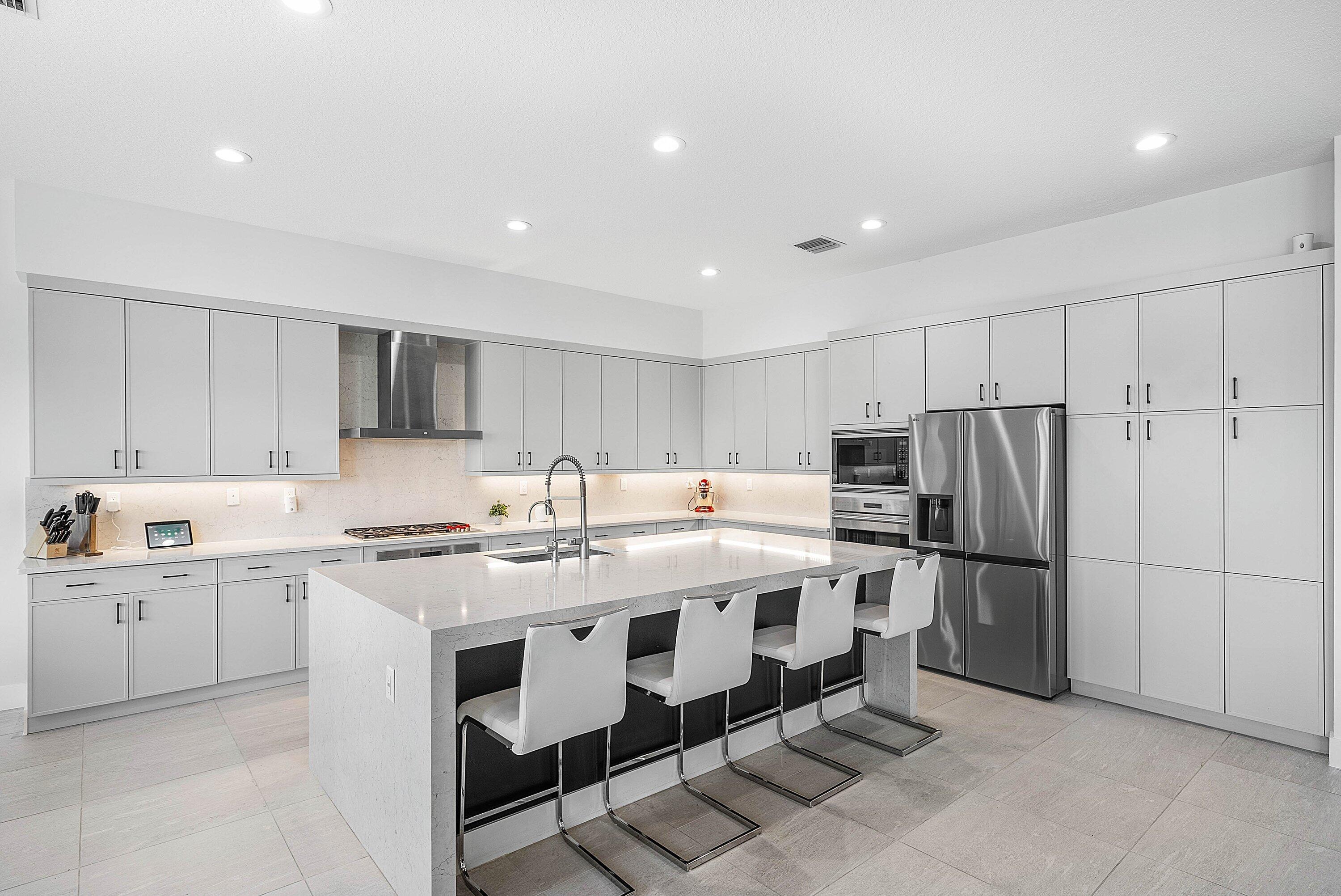 8805 New River Falls Road Boca Raton, FL 33496 - Photo 15 of 79 a kitchen with refrigerator and cabinets