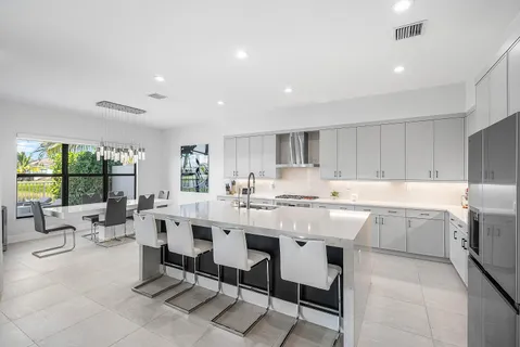 a kitchen with white cabinets sink and stainless steel appliances