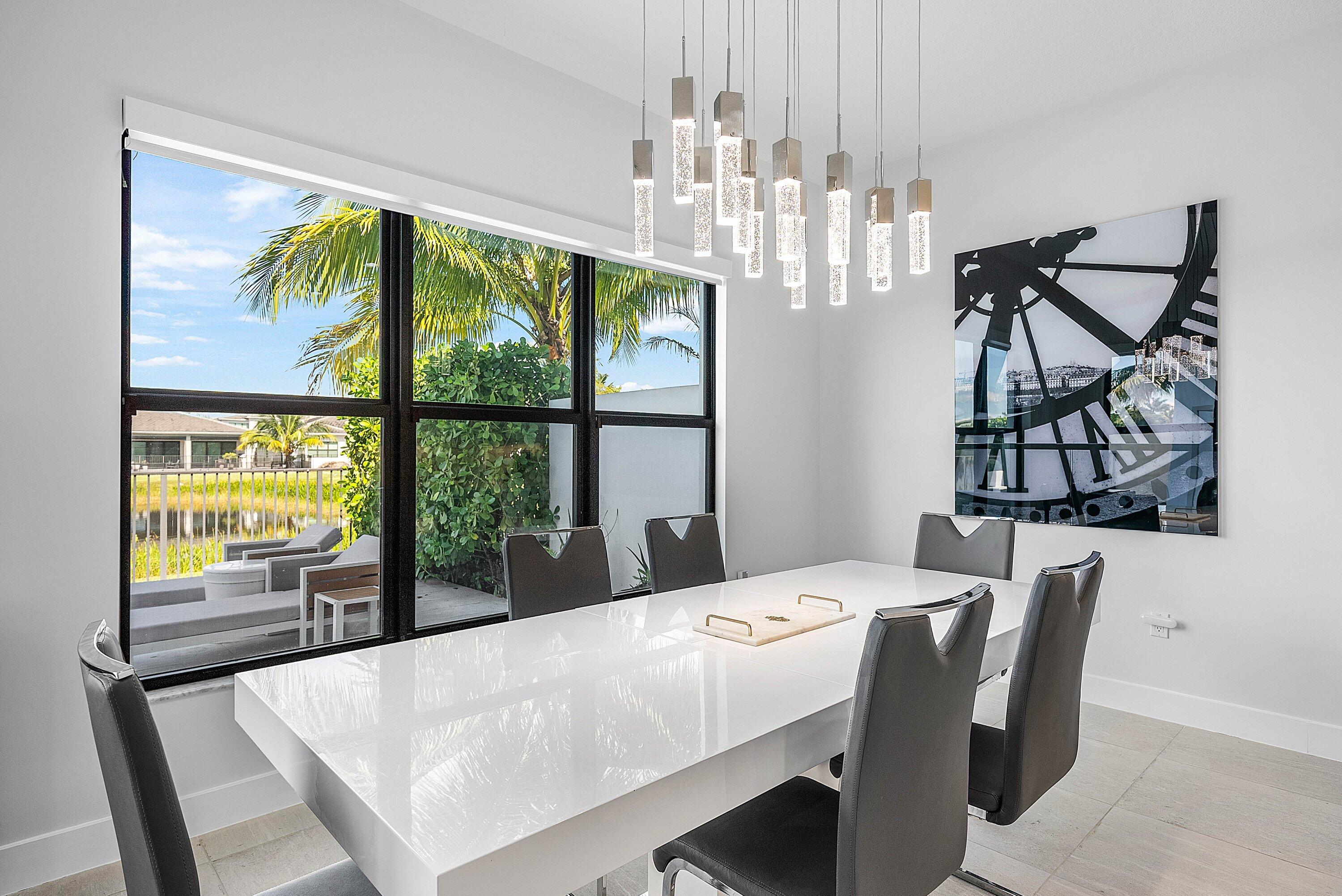 8805 New River Falls Road Boca Raton, FL 33496 - Photo 17 of 79 a view of a dining room with furniture a chandelier window and outside view