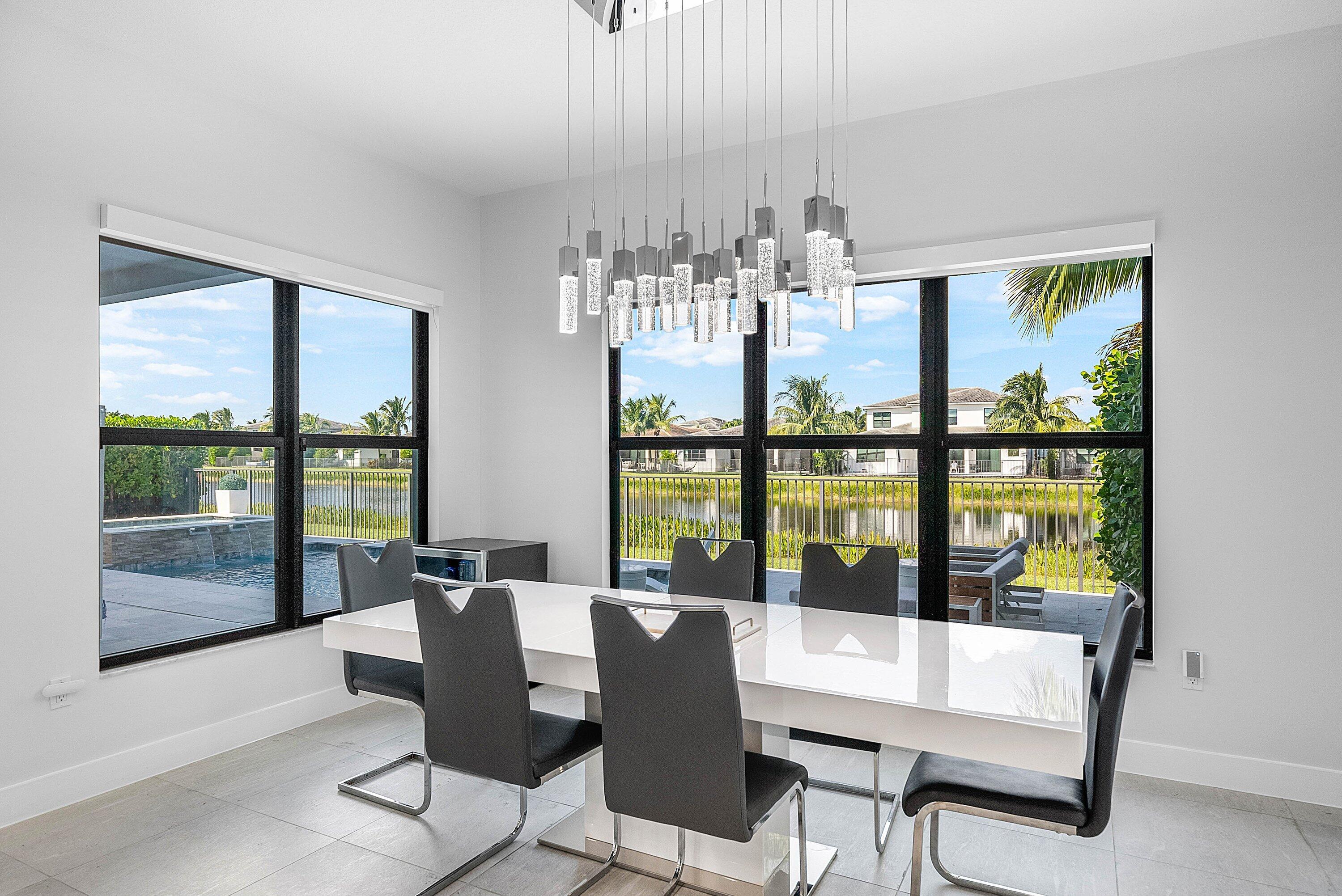 8805 New River Falls Road Boca Raton, FL 33496 - Photo 18 of 79 a view of a dining room with furniture large windows and wooden floor