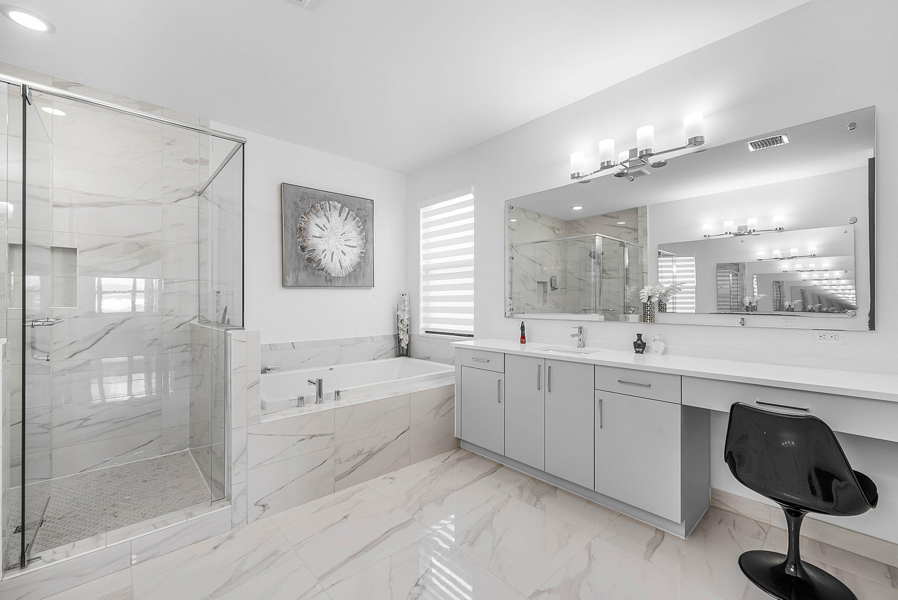 8805 New River Falls Road Boca Raton, FL 33496 - Photo 29 of 79 a spacious bathroom with a double vanity sink a mirror and a bathtub