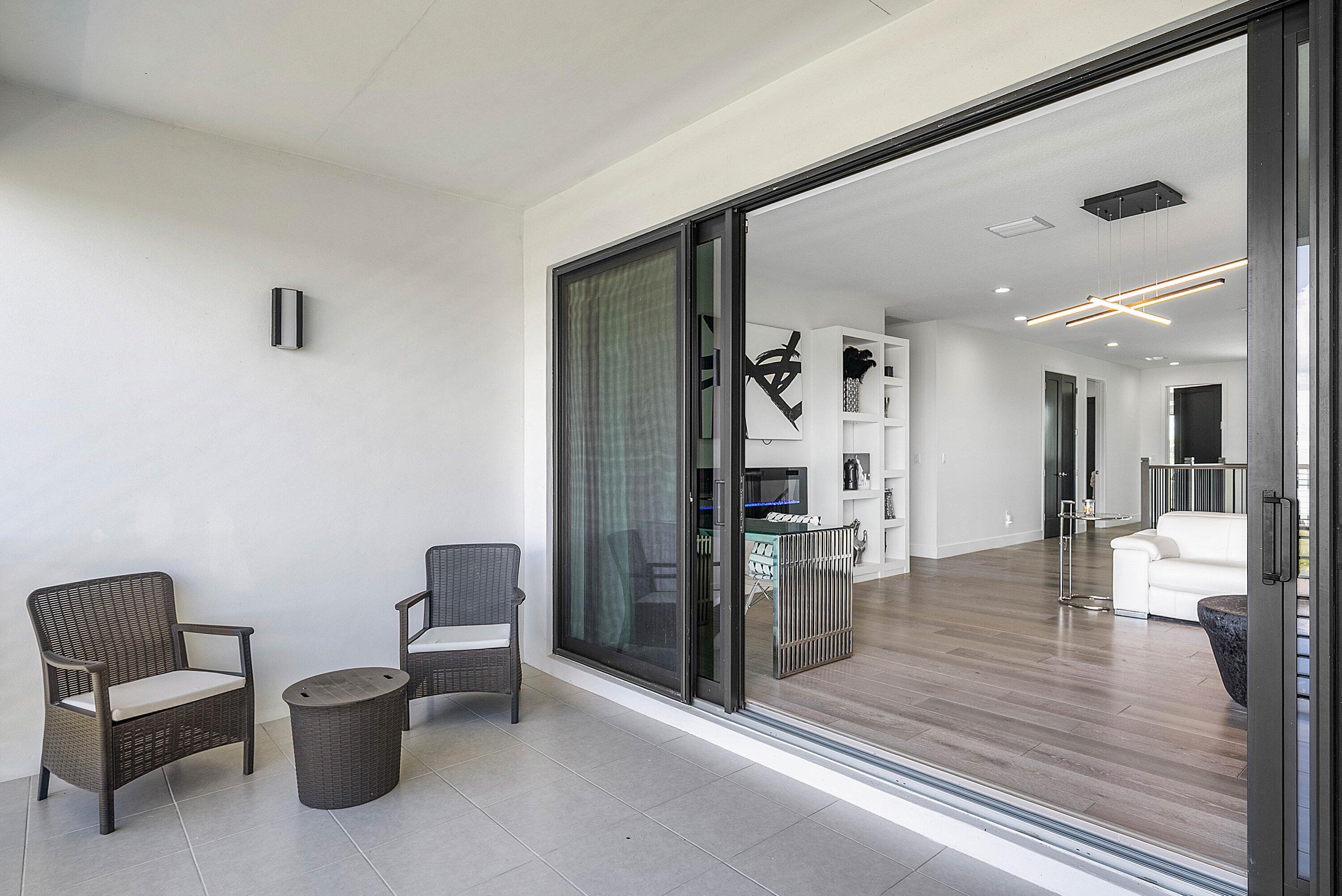 8805 New River Falls Road Boca Raton, FL 33496 - Photo 33 of 79 a living room with furniture and a wooden floor