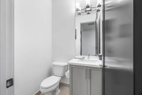 a bathroom with a sink a toilet and a mirror