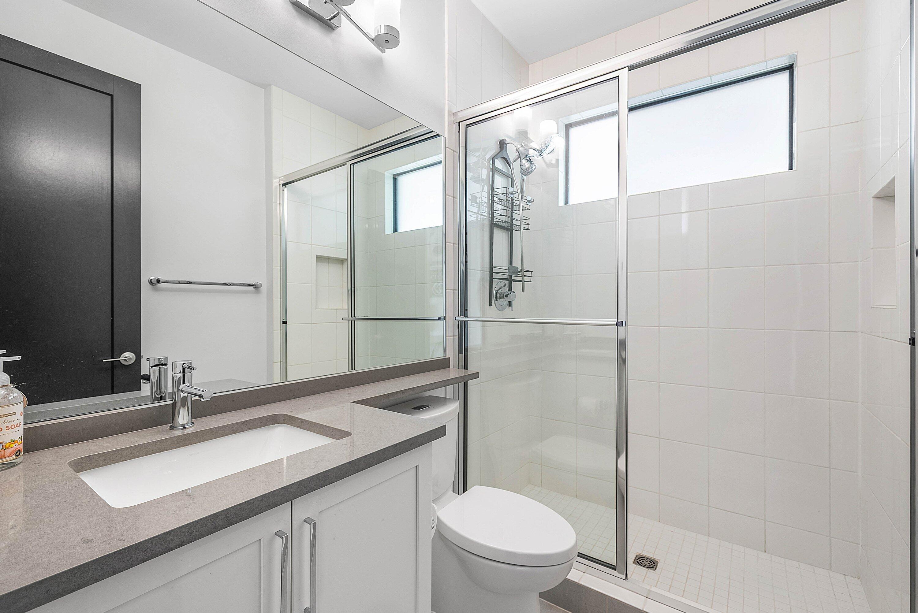 8805 New River Falls Road Boca Raton, FL 33496 - Photo 45 of 79 a bathroom with a double vanity sink toilet and shower