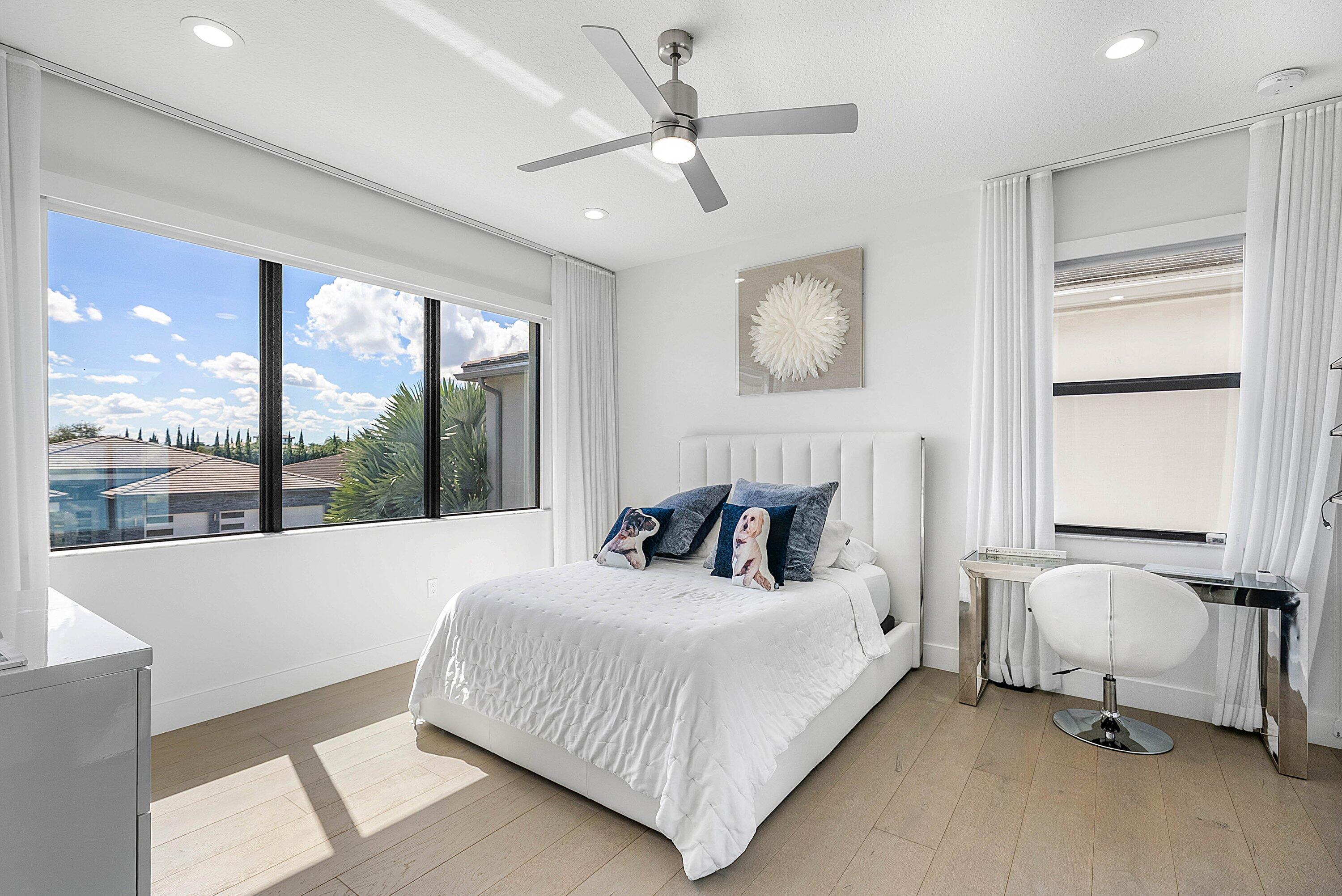 8805 New River Falls Road Boca Raton, FL 33496 - Photo 47 of 79 a bedroom with a large bed and a large window