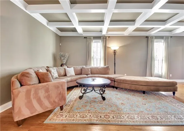 a dining room with furniture a chandelier and wooden floor