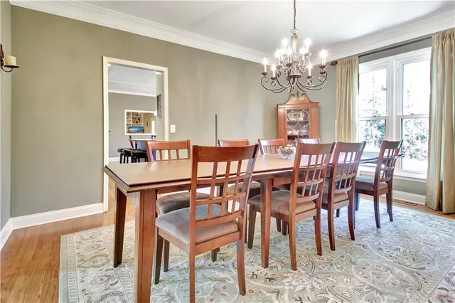 a kitchen with stainless steel appliances granite countertop a refrigerator and a wooden cabinets