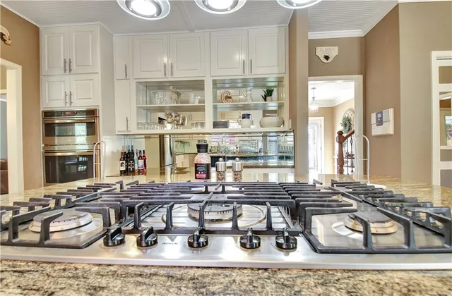 a kitchen with stainless steel appliances a refrigerator and a stove top oven