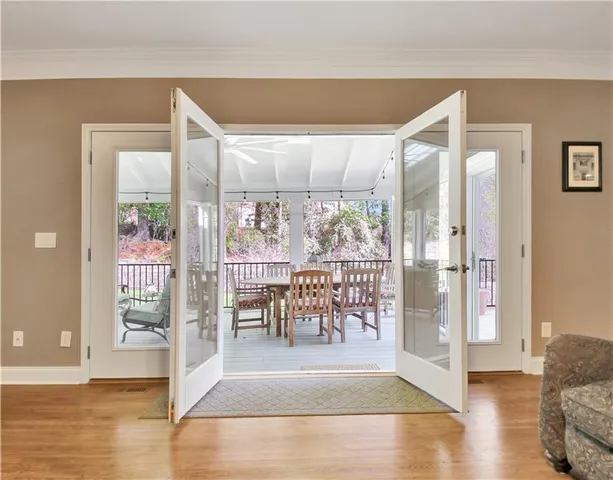 a view of a balcony with chairs and wooden floor