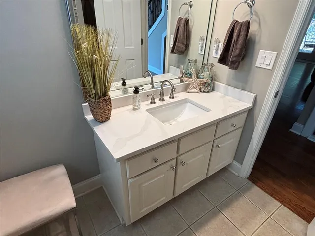 a bathroom with double sink and two mirror